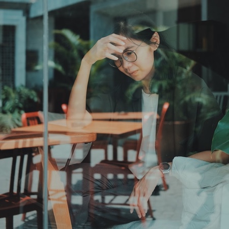 Young woman crying in a cafe