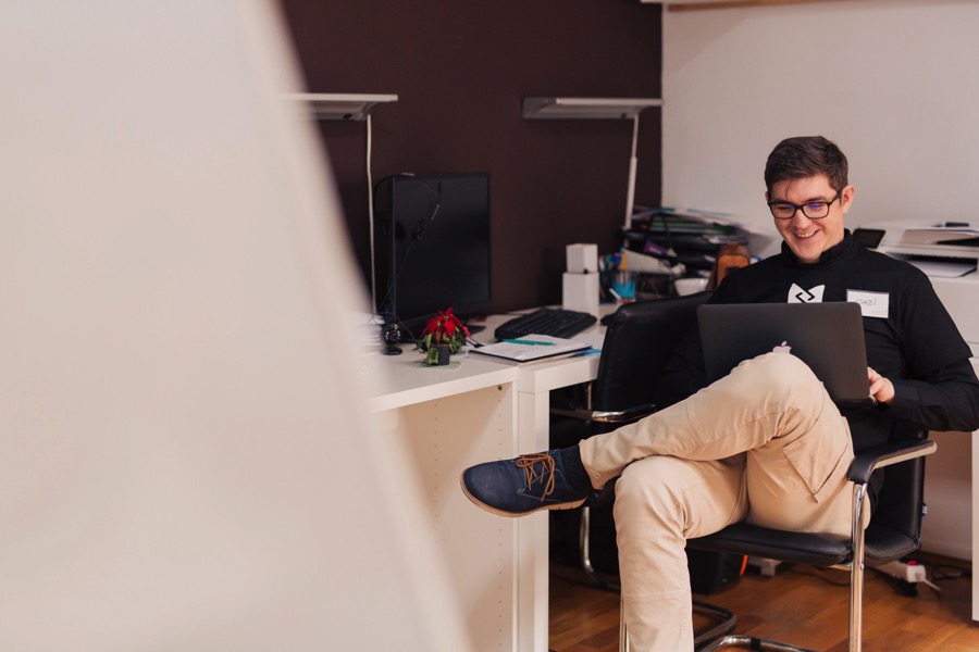 Young man at his desk writing a plan in his notebook