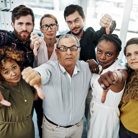 Group of professionals giving the thumbs down sign