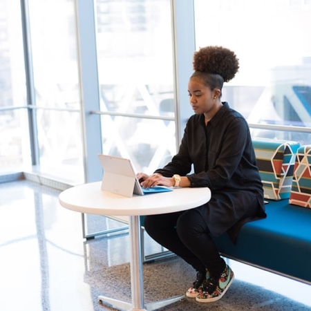 Young woman sitting at her desk doing technical work