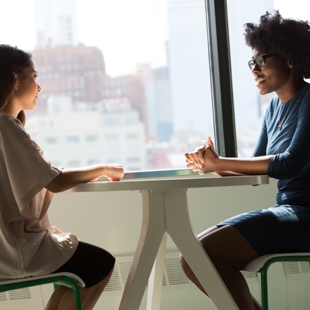 Two young people meeting with each other over coffee