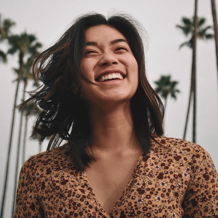 Excited young woman looking up at the sky