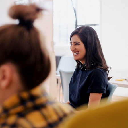 Woman smiling in the middle of a meeting